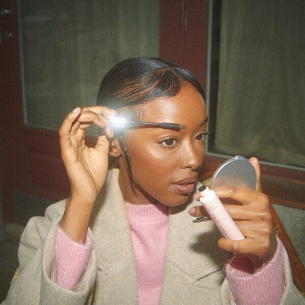 Lady applying mascara makeup