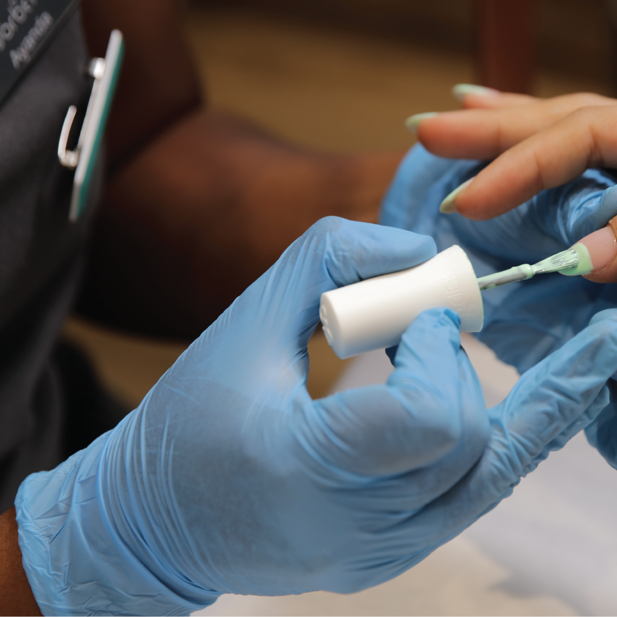 beauty therapist performing a nail treatment