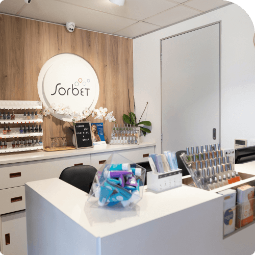 Modern beauty salon reception area with Sorbet branding, nail polish display, manicure products