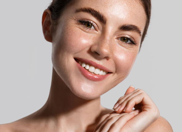 A woman with a bright smile and a fresh, clean face, exuding happiness.